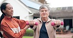 Wellness, exercise and a coach with a senior woman outdoor for a dumbbell workout for health or mobility. Fitness, physiotherapy or rehabilitation with a personal training and elderly client training