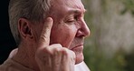Sad elderly man, thinking and window with ideas, memory and vision of life, decision or choice in home. Senior person, depression or mental health in retirement, closeup profile and headache in house