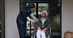 Old woman in wheelchair, garden or caregiver talking for healthcare support at nursing home. Retirement, fresh air or happy nurse speaking to African senior patient or elderly lady with a disability