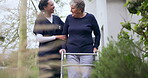 Rehabilitation, walker or nurse talking to an old woman in retirement or hospital for exercise or support. Happy, caregiver nursing or elderly patient learning mobility with walking frame in garden