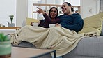 Talking, coffee and couple watching a movie on sofa in the living room for relaxing together. Conversation, laugh and young man and woman drinking cappuccino and streaming show, film or video at home