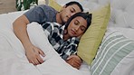 Tired, relax and couple sleeping in bed and holding hands for connection, romance and love. Rest, cuddle and young man and woman taking nap and dreaming together in the room of their modern apartment