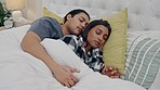 Fatigue, rest and couple sleeping in bed and holding hands for connection, romance and love. Relax, cuddle and young man and woman taking nap and dreaming together in room of their modern apartment.
