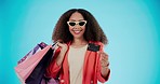 Woman with credit card, portrait and shopping bag for fashion isolated on a blue background mockup space in studio. Happy, gift and face of African customer with plastic money in sunglasses for sales