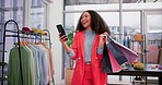 Funny, woman with shopping bag and phone in store for fashion, social media and typing online. Laughing, gift and African customer with mobile for sales discount on email in boutique, retail and mall