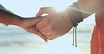 Closeup, couple and holding hands at beach for love, trust or support on a date. Calm, summer and people with a gesture of care, affection or kindness together by the ocean in summer for a vacation
