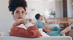 Sad, upset and woman on sofa in argument with her boyfriend for cheating, affair or toxic relationship. Mental health, moody and young female person fighting with partner in living room of apartment.