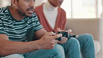 Competition, playing and a gaming couple on the sofa for winning, happiness and fun together. Smile, house and hands of a man and woman with a console for television games in the living room