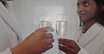 Champagne, cheers and couple relax at hotel, resort or spa with alcohol for marriage anniversary. Love, glass and toast for commitment and love with hospitality and luxury destination for holiday