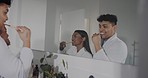 Couple, mirror and brushing teeth in bathroom for dental wellness, morning routine and self care together. Man, woman and cleaning mouth with toothbrush, reflection and happy for fresh breath at home