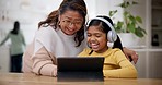 Tablet, headphones and a girl laughing with her grandma in the home living room during a family visit. Technology, meme or games with a senior woman and granddaughter browsing social media together