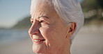 Senior woman, smile and sunset at a beach with peace outdoor in nature, sea and elderly female person with mindfulness. Relax, happy and calm old lady thinking by the ocean on holiday in retirement