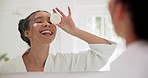 Skincare, face cream and woman in home mirror for application, cosmetic or self care in house. Reflection, beauty and happy lady in a bathroom with sunscreen, lotion or smile for dermatology wellness