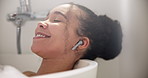 Smile, relax and woman in bubble bath with eyes closed and earphones listening to music or podcast for peace and beauty. Bathroom, girl and closeup of face with headphones for happiness and luxury