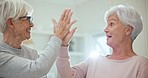 Tablet, high five and senior woman friends browsing the internet while in their home for retirement. Technology, support and motivation with elderly people using an app for good news or success