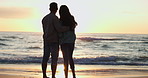 People, Couple and hug on beach, sunrise and romance on holiday in miami for happiness, bond and trust. Vacation, man and woman watch sunset and waves of ocean and sea for fresh air, sand and bonding