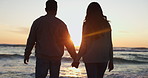 Holding hands, sunset and couple walking on a beach running on vacation or holiday together for love or care. Silhouette, man and woman with happiness on anniversary with travel freedom at ocean