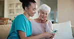 Home, senior woman and nurse on a couch, smartphone and typing with connection, network and social media. People, elderly person and caregiver on a sofa, cellphone and mobile app with online reading