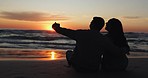 Selfie, sunset and silhouette of couple at the beach on romantic vacation, holiday or adventure. Travel, love and shadow of young man and woman taking picture by the ocean in evening on trip together