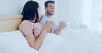 Love, morning and a couple drinking coffee in bed together while in their home to relax on a weekend. Tea, smile or happy with a man and woman talking in the bedroom of their apartment for romance