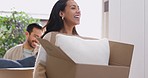 Cardboard, boxes and couple moving or walking in new house and happy with investment in real estate, property or mortgage. Dream, home and people smile and move together in living room with stairs