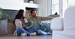 Couple, pointing and tablet in new home, floor and planning together with thinking, ideas and fresh start in living room. Asian man, woman and chat by boxes, package and moving at apartment lounge