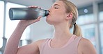 Woman, home and drink of water for fitness, energy and recovery break for workout. Thirsty athlete, bottle or nutrition of hydration, diet or healthy liquid for training, exercise or sports in lounge