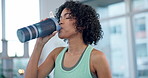 Woman, home and drink from water bottle for fitness, energy and recovery break from workout. Thirsty athlete, liquid and nutrition for hydration, diet and wellness for training, exercise and sports 