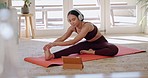 Woman, yoga and stretching with headphones in online class, fitness or zen workout on mat in living room at home. Calm female person or yogi in body warm up with tablet for tutorial or pilates lesson