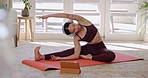 Woman, yoga and stretching body in online class, fitness or zen workout on mat with headphones in living room at home. Calm female person or yogi in warm up with tablet for tutorial or pilates lesson