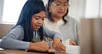 Home, grandmother and learning child with paper rip, drawing and studying for youth development project. Family grandma, dining room table and kid for education, knowledge or kindergarten homework