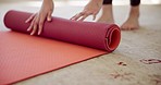 Person, hands and mat in yoga, fitness or zen workout and getting ready for exercise on floor at home. Closeup of yogi with roll out in preparation, spiritual wellness or training practice on carpet