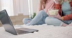 Laptop, movie and women friends on a bed with popcorn for comedy, program or film in their home. Online, video and ladies in a bedroom with snack for streaming, comic or stand up, show or documentary