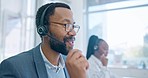 Smile, customer service and a black man consultant working in a call center for support or assistance. Contact, communication and headset with a happy employee consulting in a telemarketing office