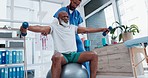 Senior care, physiotherapist and old man with dumbbell, ball and support in healthcare rehabilitation. Physio, fitness coach or caregiver with elderly patient in mobility training clinic in Africa.