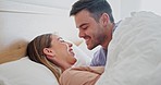 Conversation, relax and couple in bed together laughing at funny, comic or comedy joke. Happy, love and young man and woman with smile for talking, bonding and resting in the bedroom at modern home.