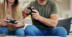 Gaming, play or hands of couple with video game in arcade competition on website online at home. Closeup, fun gamers or people streaming on digital technology to relax on house living room couch 