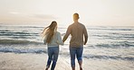 Couple, running to ocean and holding hands, beach and travel for fun, laugh and freedom outdoor. Playing in waves, romantic date and people at sunset, love and care with trust in healthy relationship