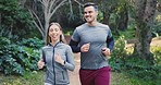 Nature, exercise and couple running, fitness and training with workout, challenge and fresh air. Healthy people, man or woman in the woods, runner or path in a forest with motivation, smile or cardio