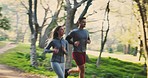 Forest, fitness and couple running, workout and wellness with training, challenge and fresh air. Healthy people, man and woman in the woods, runner and exercise with motivation, cardio and energy