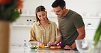 Ingredients, cooking and couple in the kitchen together for bonding with gourmet recipe. Happy, smile and young man and woman cutting vegetables for preparing a dinner, supper or lunch meal at home.