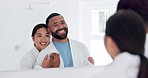 Love, happy and young couple in the bathroom for health, wellness and morning routine together. Smile, mirror and interracial man and woman hugging before self care treatment at modern apartment.