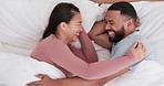 Happy couple, bed and laughing in funny morning, joke or relax together on holiday, weekend or break at home. Man and woman smile lying in bedroom happiness, wake up or humor in bonding at house