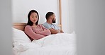 Couple in bed, conflict and anger with stress and communication fail in marriage and risk of divorce. Fight, frustrated people in bedroom at home and crisis, betrayal and broken trust in relationship