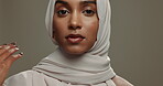 Face, muslim hijab or woman on studio background for beauty, fashion or arabic culture in Saudi Arabia. Serious portrait, young islamic model or scarf style of religion, elegant clothes or confidence