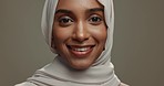 Face, muslim or happy woman in hijab on studio background for natural beauty, fashion or arabic culture in Saudi Arabia. Portrait, young islamic model or smile for scarf style, religion or confidence