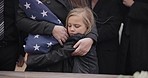 Sad, hug and a child at a funeral or graveyard for a ceremony or death with family. Depression, young and a girl kid with a person for comfort at a cemetery for mourning, grief together or loss