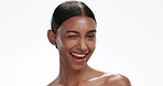 Face, skin and woman with wink, beauty and natural cosmetics for wellness on white background. Portrait of Indian model, flirt and skincare with dermatology in studio, headshot with mockup space