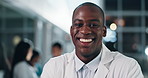 Man, face and doctor with smile for healthcare services, surgery or help in busy hospital at night. Portrait of happy african surgeon, expert therapist or medical professional working late with trust