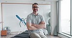 Chiropractor, physiotherapy and face of man with crossed arms for wellness, reflexology and physical therapy. Healthcare, professional and portrait of happy person for rehabilitation medical service